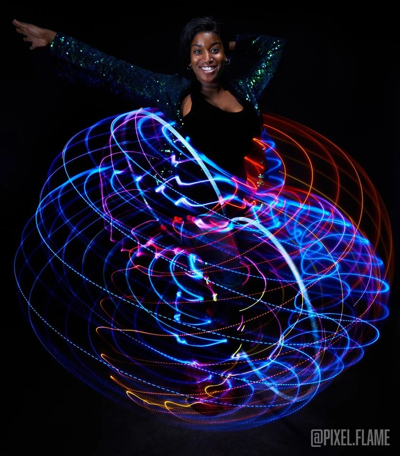 Spinsterz performers with fire hoops, an LED hoop and fire fans