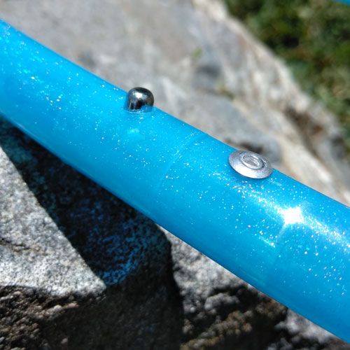 Close up of blue glitter polypro hula hoop handmade by The Spinsterz in Boulder Colorado. 
